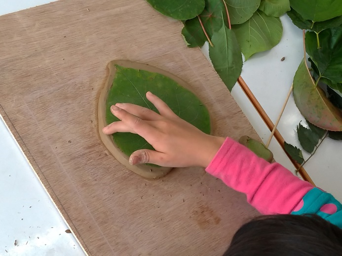 學生在陶土上拓印植物形狀與葉脈